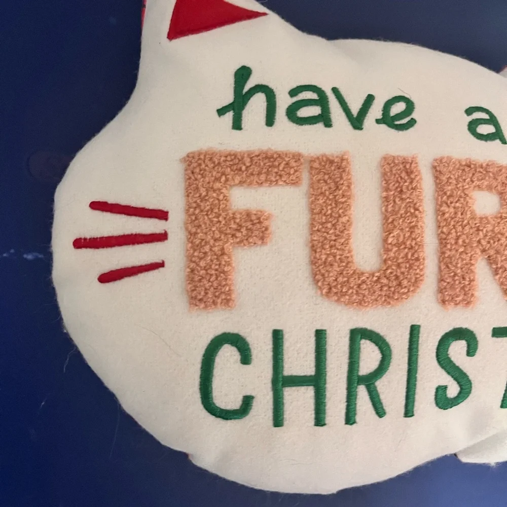 Wonder shop have a very furry Christmas cat pillow